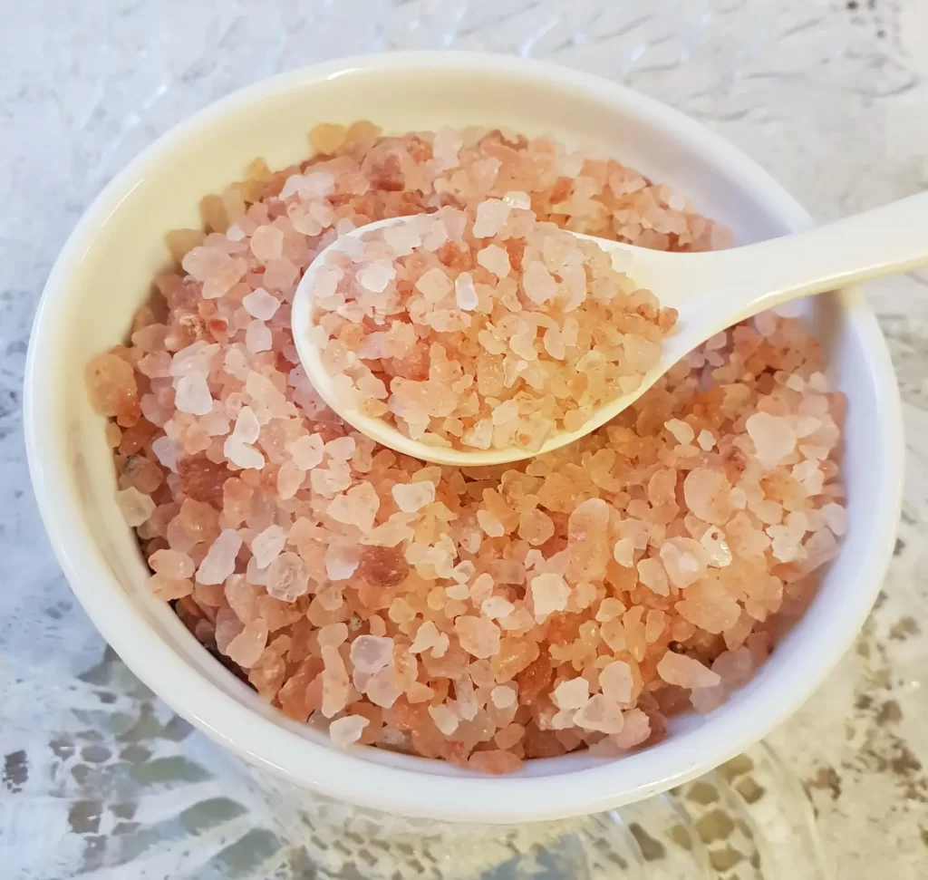 Coarse Himalayan salt in a bowl with a spoon